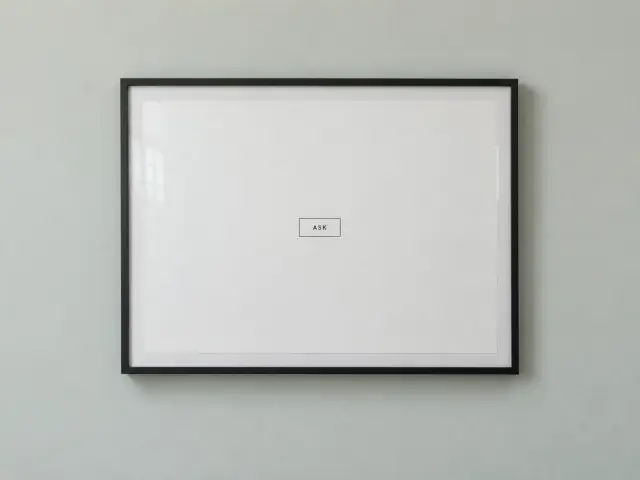A framed ink sitemap on a wall with a single box in the middle labeled Ask.